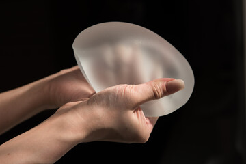Silicone implant of the female breast during the demonstration of its quality.