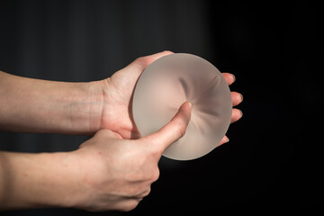 Silicone implant of the female breast during the demonstration of its quality.