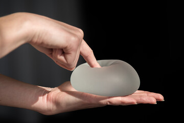 Silicone implant of the female breast during the demonstration of its quality.