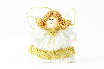 Smiling handmade Christmas angel isolated on white. An ornament made of a fabric on a white background.