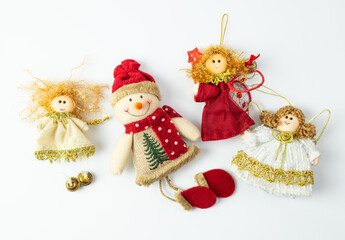 Christmas snowman surrounded by angels. Handmade fabric ornaments. White background with place for text.