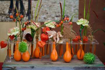 Flower mix in orange flower vases