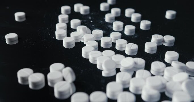 pills crumbled on a black background