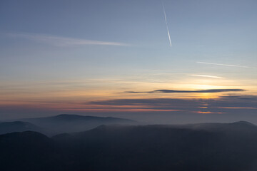 Autumn sunset above foggy hills