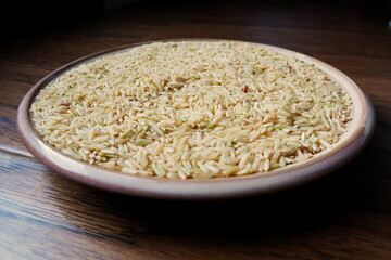 Bowl of brown rice on wood
