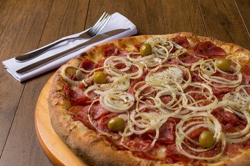 Pepperoni pepperoni pizza. Fast food. Restaurant and pizzeria. Close-up photography.