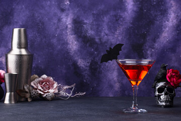 Halloween martini cocktail on purple background