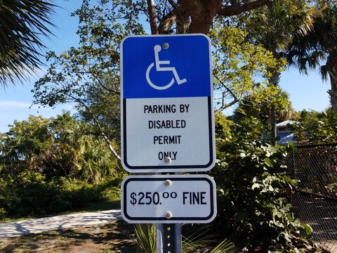 parking by disabled permit only sign with fine