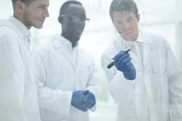 promising scientist makes notes on the Board