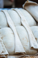 Making craft bread at the bakery. Close-up of a baker and bread, blurred background