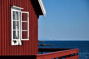 Fototapeta na wymiar Red Norway house at the seaside.