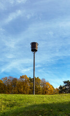 Fire basket on a pole at the top of the hill, season autumn