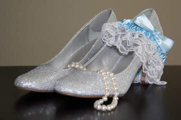 wedding shoes, garter and pearls necklace for a wedding