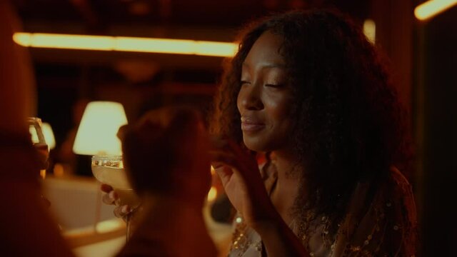 African woman dancing in restaurant. Beautiful lady having rest in nightclub