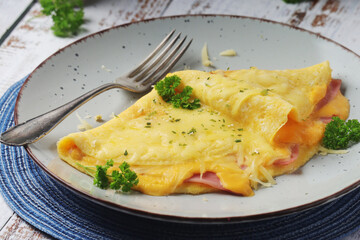 Omelette with ham and cheese on the plate
