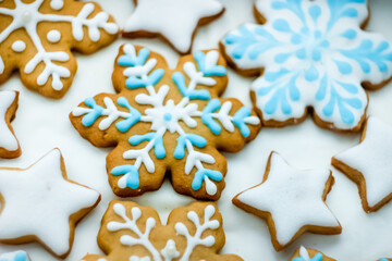 Fototapeta na wymiar Colorful Christmas ginger cookies in the form of snowflakes and stars