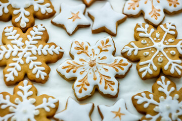 White and golden Christmas ginger cookies in the form of snowflakes