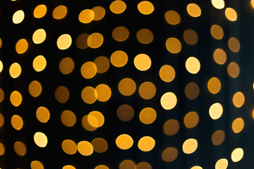 .Christmas background from bokeh from Christmas garlands on a black background