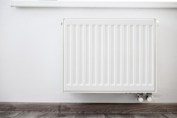 white heating radiator on the wall