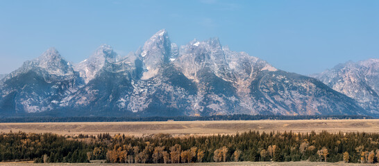 Grand Teton mountain range forest and valley 2 Panorama. Destination for mountaineering, hiking, fishing and recreation. Geography, geology, environment, history, landscape and natural beauty.