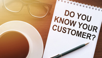 You Know Your Customers - Text on Paper with Cup of Coffee and Glasses on Wooden Background in Sunlight. Business concept.