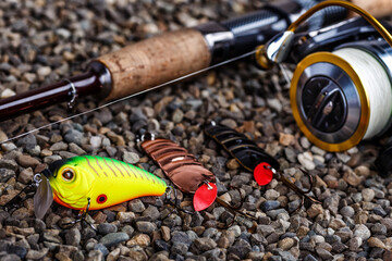 Fishing theme.Fishing tackle - fishing spinning, lures and wobblers.Closeup of a fishing box with...