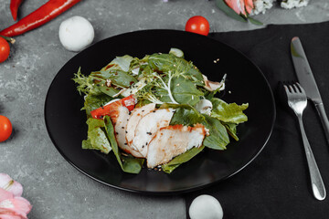 smoked chicken salad on a black plate