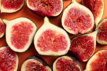 Delicious ripe figs on orange background, flat lay