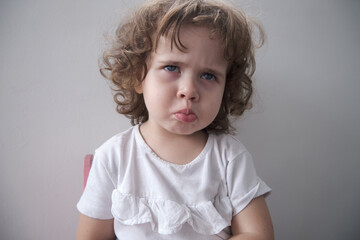 Naklejka premium Little Brazilian girl making angry face at camera