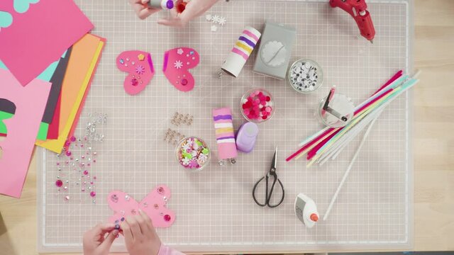 Flat lay. Kids papercraft. Making paper bugs out of the empty toilet paper rolls and construction paper.