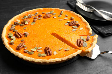 Delicious homemade pumpkin pie on black table