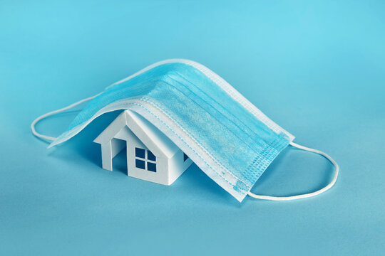 Paper House Model Cover By A Mask Isolated On Blue Backgrund