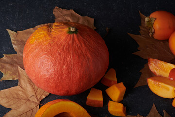 Autumnal vegetables and fruits, Pumpkin, sliced and whole, fresh and raw
