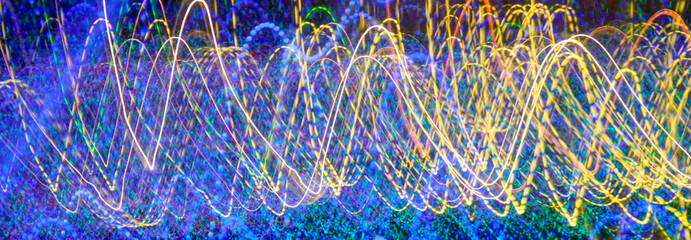 Colorful laser lights in motion flowing in a pattern. Abstract streaming light pattern.