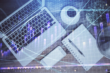 Financial market graph and top view computer on the desktop background. Double exposure. Investment concept.
