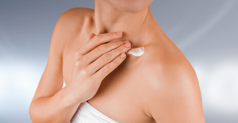 Fototapeta premium Young beautyful slim woman with smooth shiny skin applying natural body cream on hip. Natural manicure, white underwear.