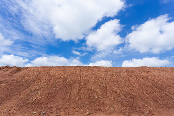 Background landscape of blue sky with clouds over cracked desert earth