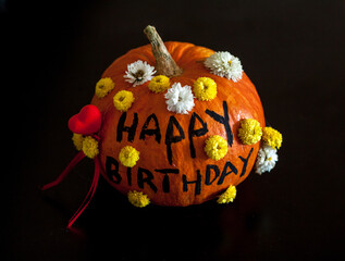 Happy birthday pumpkin decorated with flowers 