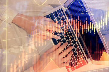 Double exposure of woman hands working on computer and forex chart hologram drawing. Top View. Financial analysis concept.