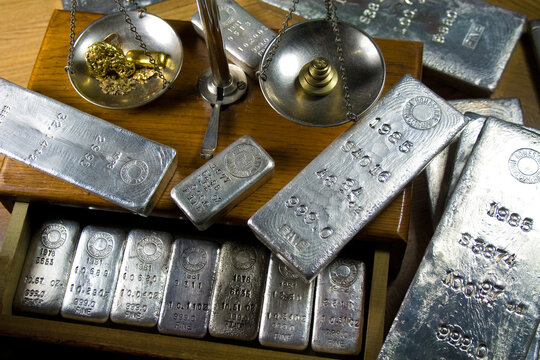 Homestake Mining Company silver bullion bars. Now closed mine located at Lead, South Dakota - Black Hills, USA. Gold bar and raw nuggets on antique balance scale.