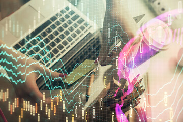 Double exposure of businesswoman hands typing on computer and financial graph hologram drawing. Stock market analysis concept.