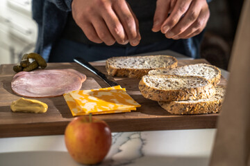 Man's Hands Preparing Simple Sandwich on Kitchen Counter