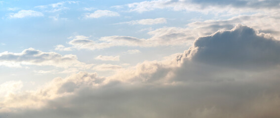 Cloudy sky at sunset or sunrise. Sky in the lilac and blue colors. Light pastel colored sunset clouds. Magnificent panoramic cloudscape
