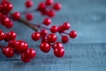 Christmas decorations red berries on a wooden background