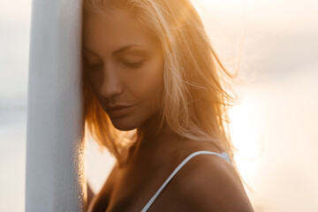 Beautiful surfer woman on the beach at sunset. Bali Indonesia.