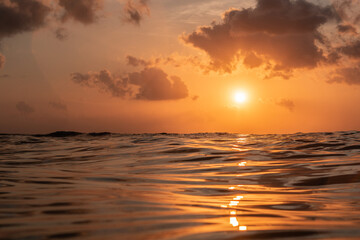 Fototapeta na wymiar Golden sunset in tropical island Bali from the ocean