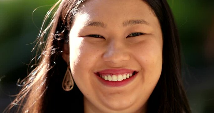 Happy Asian woman portrait face close-up smiling to camera
