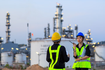 Smart two female engineer discussion together at refinery industry plant at industry factory center area. Engineering Concept