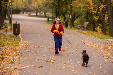 Fototapeta premium Happy kid in motion in autumn park