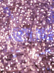 Christmas and new year lights. Blurred lights of light purple. Can be used as background and texture